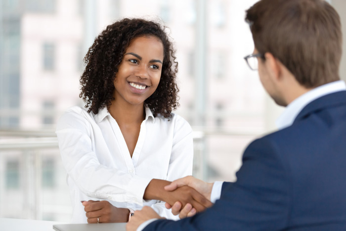 job applicant shaking hands during job interview